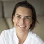 Portrait of a smiling woman in white shirt, Tinka, team member of NegotiationWize